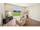 Comfortable living area with sliding glass doors offering serene outdoor views at 10211 Ura Ln # 3-104, Thornton, CO 80260