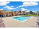 Community pool with lounge chairs, a lifeguard station, and apartment buildings at 10211 Ura Ln # 3-104, Thornton, CO 80260