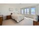 Bright bedroom with large windows providing natural light and views, and an antique-style dresser at 7672 E Arizona Dr, Denver, CO 80231