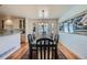 Bright dining room featuring a large table, hardwood floors, and a large window at 7672 E Arizona Dr, Denver, CO 80231