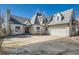 Charming home featuring a multi-car garage, distinctive roofline, and a well-maintained front yard at 7672 E Arizona Dr, Denver, CO 80231