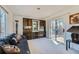 Bright living room featuring a sliding glass door that leads to an outdoor balcony at 7672 E Arizona Dr, Denver, CO 80231