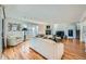 Spacious living room featuring hardwood floors, a fireplace, and bright natural light at 7672 E Arizona Dr, Denver, CO 80231