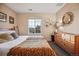 Well-lit bedroom with a dresser and window views at 24758 E Arizona Cir, Aurora, CO 80018