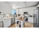 Modern kitchen with white cabinets and a kitchen island at 24758 E Arizona Cir, Aurora, CO 80018