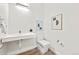 Bathroom featuring a modern floating sink, toilet and minimalist decor at 9510 Orion Way, Arvada, CO 80007