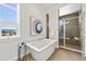 Bathroom featuring a soaking tub with a shower and a view of the neighborhood at 9510 Orion Way, Arvada, CO 80007