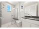 Modern bathroom featuring a glass shower, gray quartz countertop, and sleek white cabinetry at 9510 Orion Way, Arvada, CO 80007