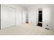 Bright bedroom featuring a doorway to an ensuite bathroom and a closet at 9510 Orion Way, Arvada, CO 80007
