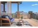 Outdoor deck featuring a built-in grill and comfortable seating area at 9510 Orion Way, Arvada, CO 80007