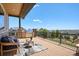 Relaxing deck area with outdoor seating and a beautiful view of the surrounding neighborhood at 9510 Orion Way, Arvada, CO 80007