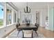 Elegant dining room with a modern chandelier, large windows, and stylish decor at 9510 Orion Way, Arvada, CO 80007