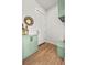 Hallway featuring a built-in bench, storage cabinets, and wooden floors at 9510 Orion Way, Arvada, CO 80007