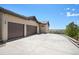 Spacious driveway leading to a three-car garage in a well-maintained home at 9510 Orion Way, Arvada, CO 80007