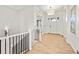 Bright foyer with hardwood floors, a staircase with black iron railing, and front door at 9510 Orion Way, Arvada, CO 80007