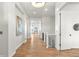 Bright hallway with hardwood floors, white walls, modern lighting, and staircase leading to other floors at 9510 Orion Way, Arvada, CO 80007