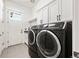 Bright laundry room featuring black front-loading washer and dryer at 9510 Orion Way, Arvada, CO 80007