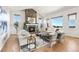 Spacious living room with a stone fireplace, hardwood floors, vaulted ceilings, and modern decor at 9510 Orion Way, Arvada, CO 80007