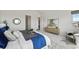 Bright main bedroom with neutral decor, a cozy seating area, and large windows at 9510 Orion Way, Arvada, CO 80007
