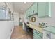 Stylish office space with built-in desk, light green cabinets and ample storage at 9510 Orion Way, Arvada, CO 80007
