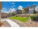 Spacious backyard features lush green grass, tiered landscaping, and stone pavers to provide a relaxing outdoor space at 12636 Sandstone Dr, Broomfield, CO 80021