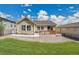 Landscaped backyard with a small wooden deck and stone landscaping, perfect for outdoor entertaining at 12636 Sandstone Dr, Broomfield, CO 80021