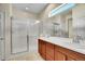 This bathroom features a double sink vanity and a walk-in shower with glass door at 12636 Sandstone Dr, Broomfield, CO 80021