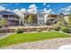 Well-maintained community with manicured lawns and attractive residential buildings on a sunny day at 12636 Sandstone Dr, Broomfield, CO 80021