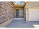 Inviting front porch with stone facade and concrete steps leads to the home's entrance at 12636 Sandstone Dr, Broomfield, CO 80021