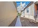 Narrow stone-covered side yard in between houses with a concrete pathway, ideal for storage or utility access at 12636 Sandstone Dr, Broomfield, CO 80021