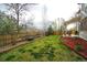 Large backyard with a wood fence providing privacy, along with a patio and lush lawn at 17722 E Ida Ave, Centennial, CO 80015