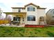 Spacious backyard with a covered patio, lawn, and garden area, perfect for outdoor gatherings at 17722 E Ida Ave, Centennial, CO 80015