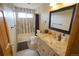 Updated bathroom featuring a granite countertop, vanity, and tiled shower, creating a comfortable and functional space at 17722 E Ida Ave, Centennial, CO 80015