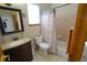 Cozy bathroom features a shower-tub combo with a patterned curtain and updated vanity at 17722 E Ida Ave, Centennial, CO 80015