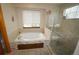 Elegant bathroom featuring a jetted tub, separate shower, and neutral tile, perfect for relaxation at 17722 E Ida Ave, Centennial, CO 80015
