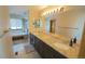 Luxurious bathroom with dual sinks, granite countertops, large mirror, and a separate tub and shower area at 17722 E Ida Ave, Centennial, CO 80015