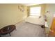 Bright bedroom with neutral walls, carpeted floors, and a cozy bed near a window at 17722 E Ida Ave, Centennial, CO 80015