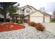 Charming two-story home featuring a well-manicured front yard with mature trees at 17722 E Ida Ave, Centennial, CO 80015
