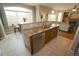 Open-concept kitchen with island, granite countertops, stainless steel dishwasher, and eat-in breakfast bar at 17722 E Ida Ave, Centennial, CO 80015
