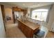 Spacious kitchen island with stainless steel appliances, wood cabinets and granite countertops at 17722 E Ida Ave, Centennial, CO 80015