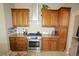 Traditional kitchen with wood cabinets, granite countertops, and stainless steel appliances at 17722 E Ida Ave, Centennial, CO 80015