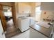 Well-organized laundry area with new washer and dryer and natural light at 17722 E Ida Ave, Centennial, CO 80015