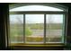 Scenic view from a large window overlooking a landscaped area with mature trees and a roadway at 17722 E Ida Ave, Centennial, CO 80015
