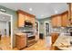 Well-lit kitchen features wooden cabinets, stainless steel appliances, and attractive countertops at 2680 S Garfield Cir, Denver, CO 80210