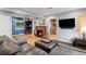 Open concept living room with hardwood floors, fireplace, and blue accent wall at 2680 S Garfield Cir, Denver, CO 80210