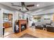 Bright living room with hardwood floors, fireplace, ceiling fan, and lots of natural light at 2680 S Garfield Cir, Denver, CO 80210