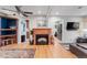 Spacious living room featuring hardwood floors, a fireplace, and modern decor at 2680 S Garfield Cir, Denver, CO 80210