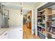 Pantry between kitchen and laundry features organized shelving and ample storage space at 2680 S Garfield Cir, Denver, CO 80210