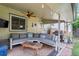 Inviting outdoor patio with comfortable seating, ceiling fan, and string lights at 2680 S Garfield Cir, Denver, CO 80210