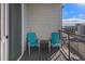 Private balcony with teal chairs and a small table at 9287 Twenty Mile Rd # 401, Parker, CO 80134